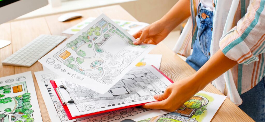 Person looking at plans and landscaping drawings